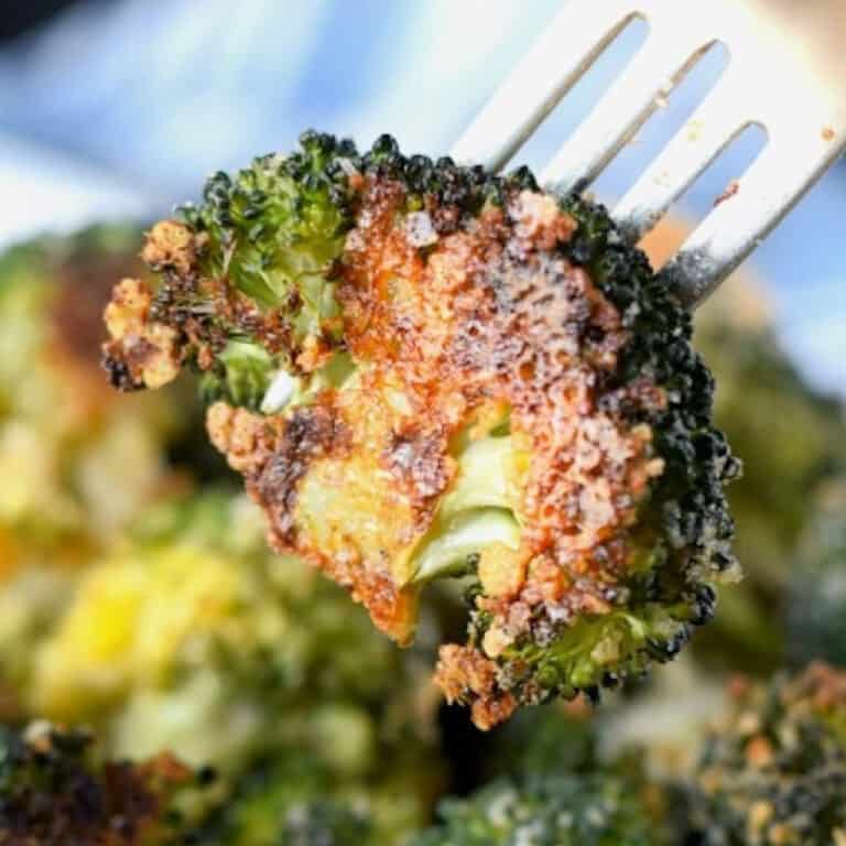 Broccoli floret being picked up with a fork.