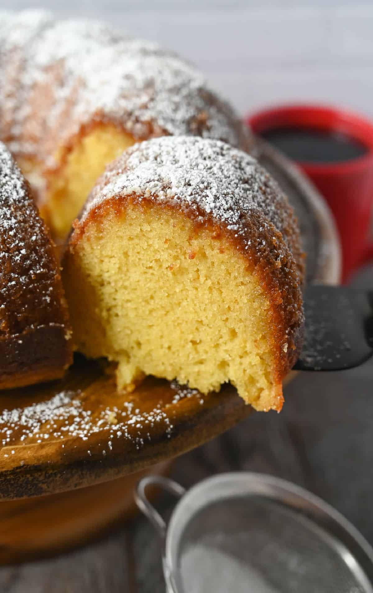 A slice of rum cake being cut.