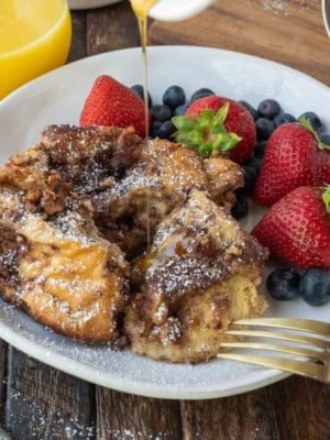 French toast casserole on a plate with fruit.
