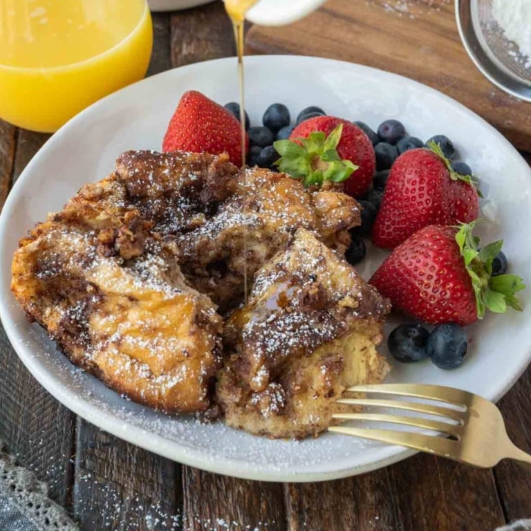 French toast casserole on a plate with fruit.