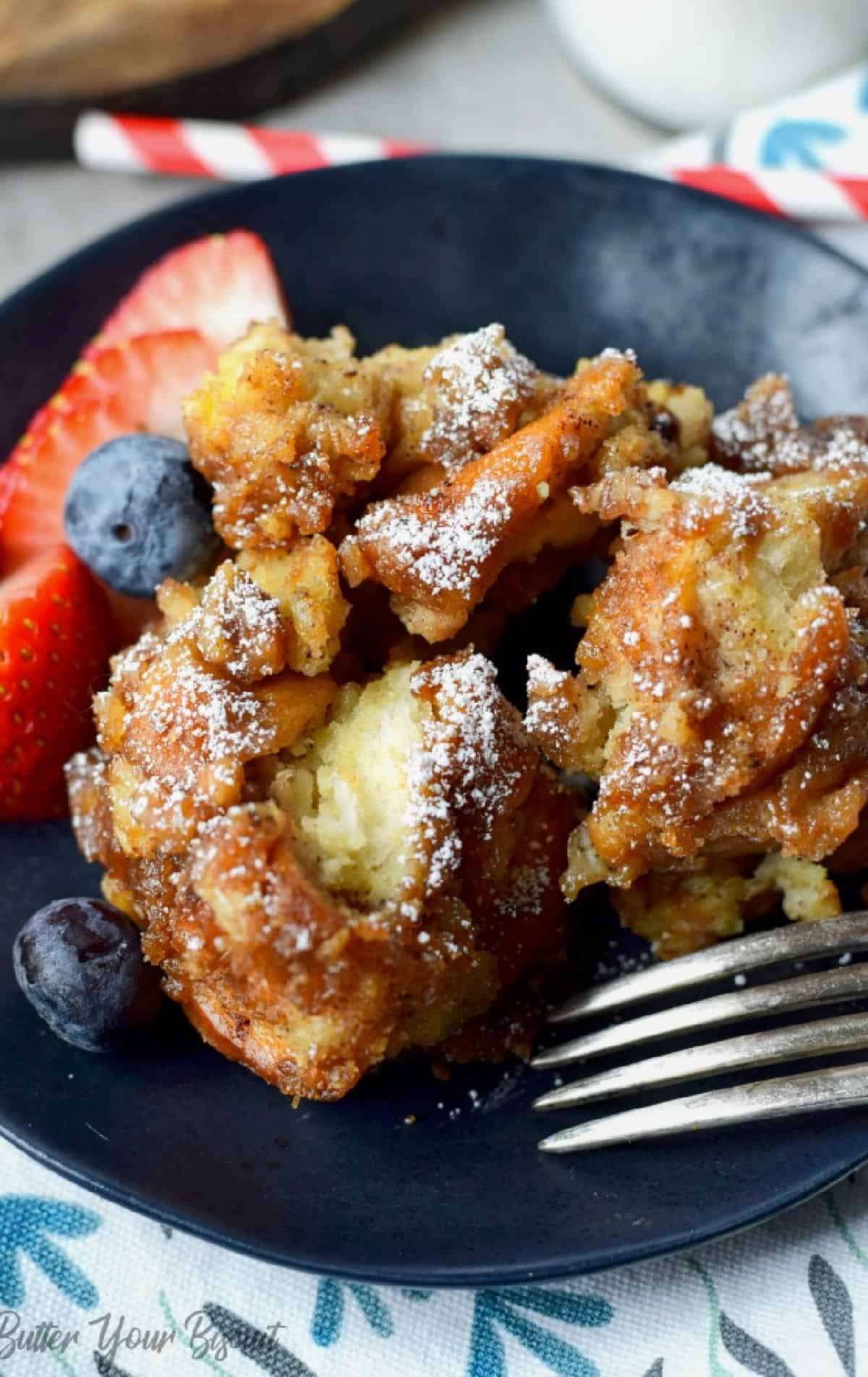 French toast casserole with fruit on a plate.