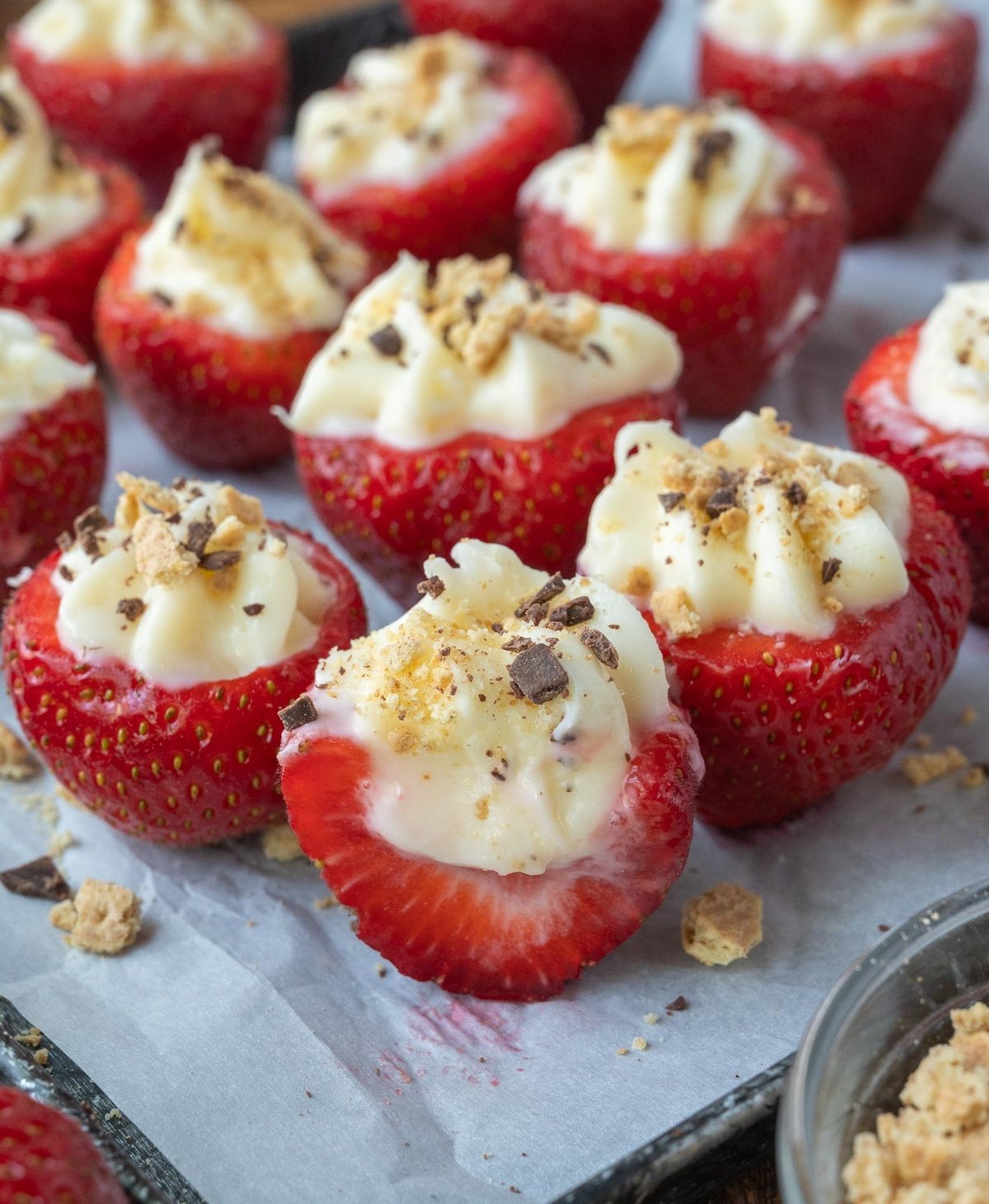 Stuffed strawberries on a baking sheet.