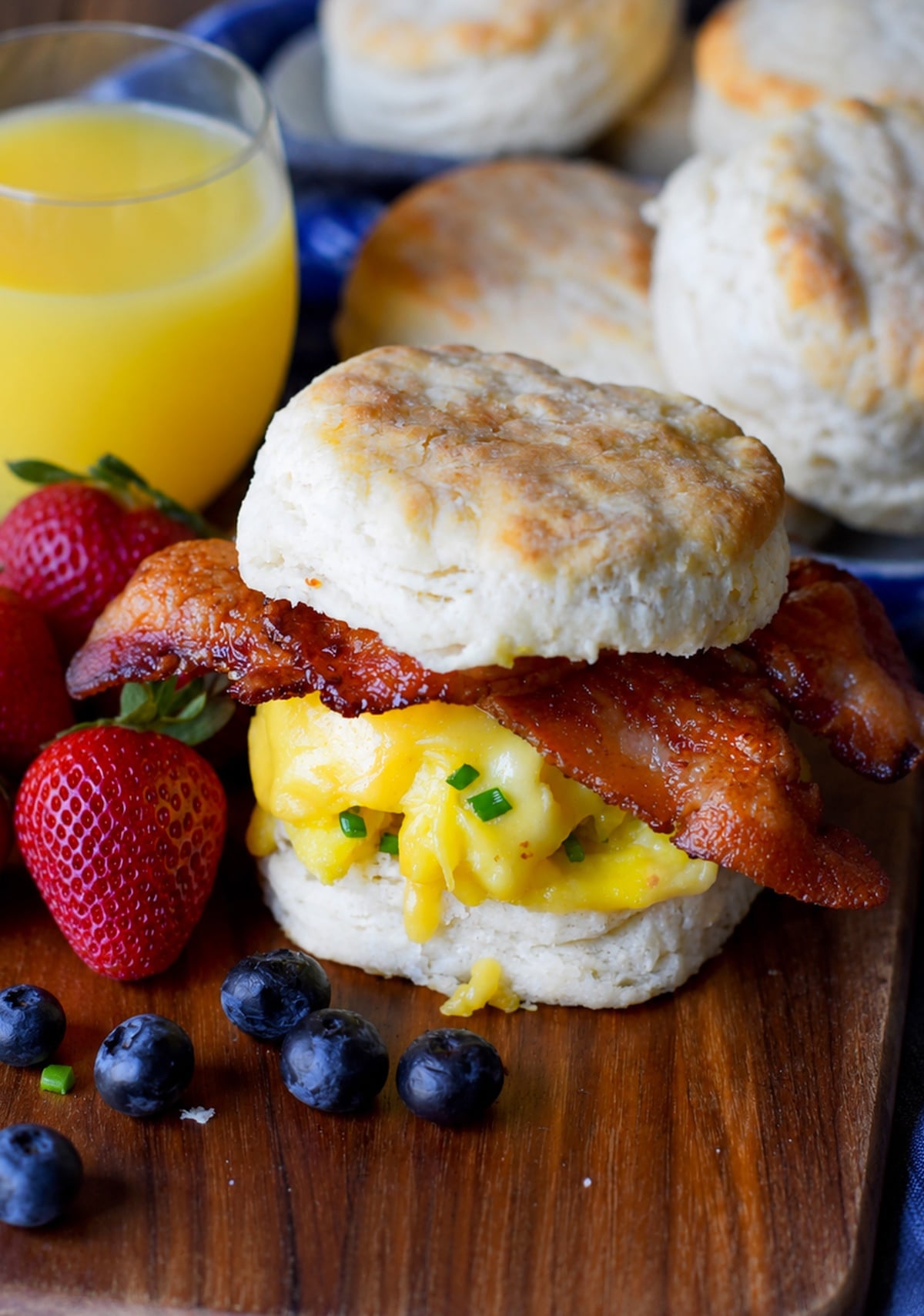 Bacon egg and cheese biscuit on a cuttin board.