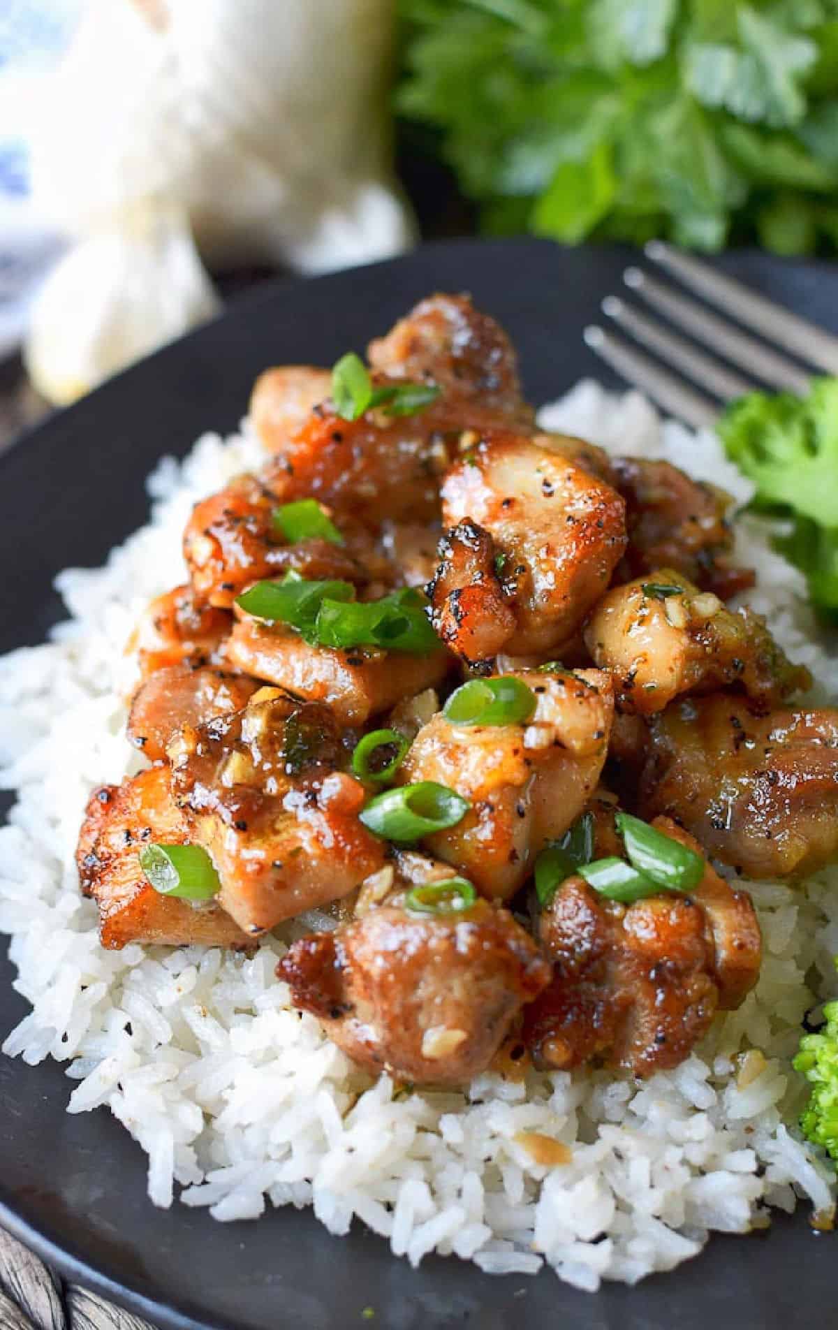 Honey butter chicken on a bed of white rice.