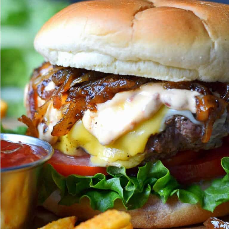 Cheeseburger with a side of fries and ketchup.