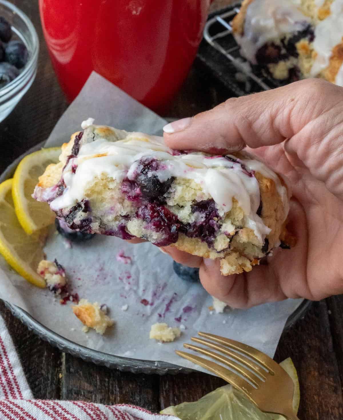 Blueberry scone being picked up.