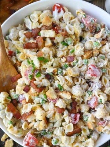 Bacon ranch pasta salad in a white serving bowl.