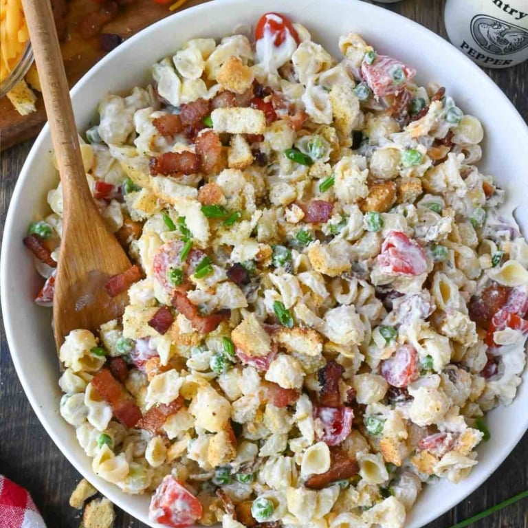 Bacon ranch pasta salad in a white serving bowl.