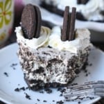 Oreo cheesecake slice on a plate.