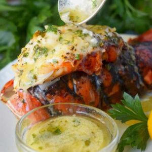 A large lobster tail with butter on top.