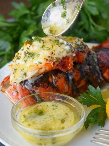A large lobster tail with butter on top.