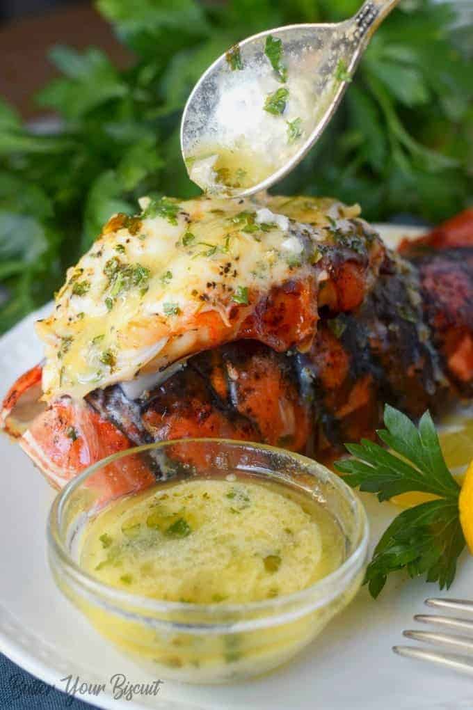 A large lobster tail with butter on top.