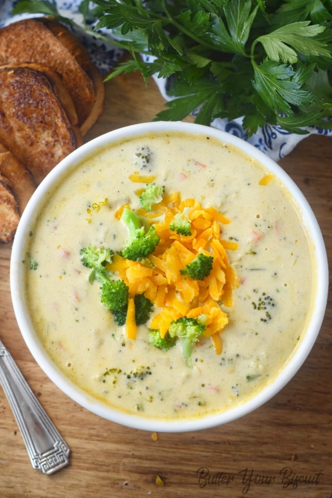 A boel of broccoli cheese soup in a white bowl.