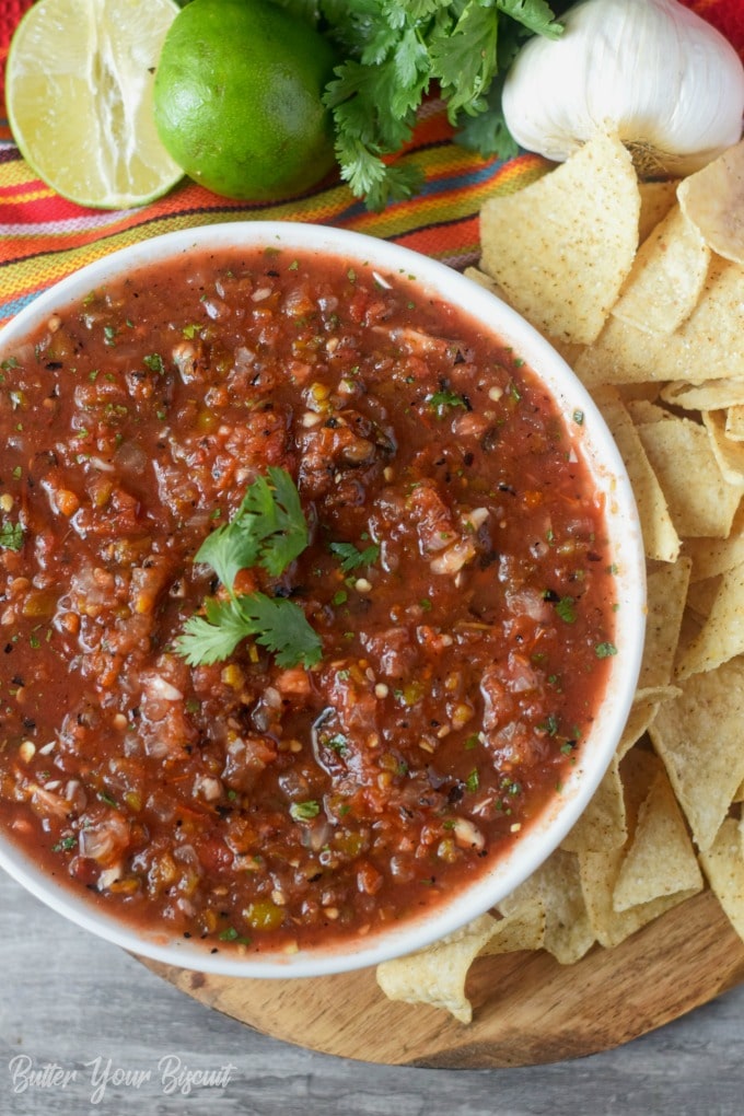 A bowl of salsa with tortilla chips.