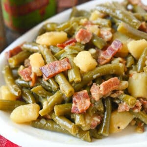 Southern green beans on a white plate.