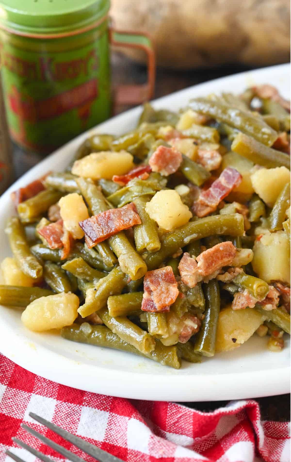 Southern green beans on a white plate.