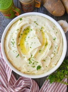 A white bowl with creamy mashed potatoes.