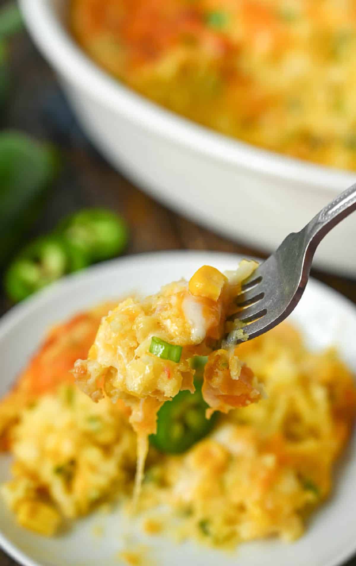 A fork picking up a bite of corn casserole.