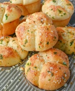 Garlic parmesan dinner rolls in muffins tins.