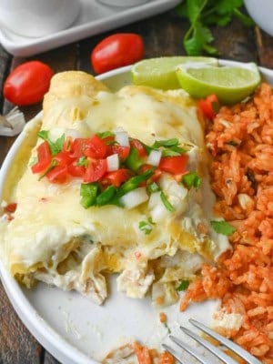 Green chile chicken enchiladas on a plate.
