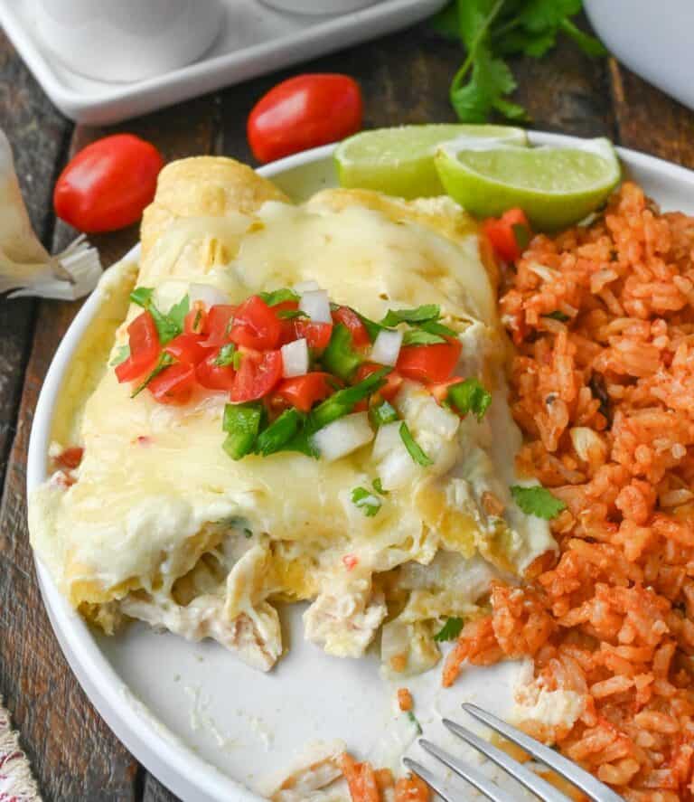Green chile chicken enchiladas on a plate.