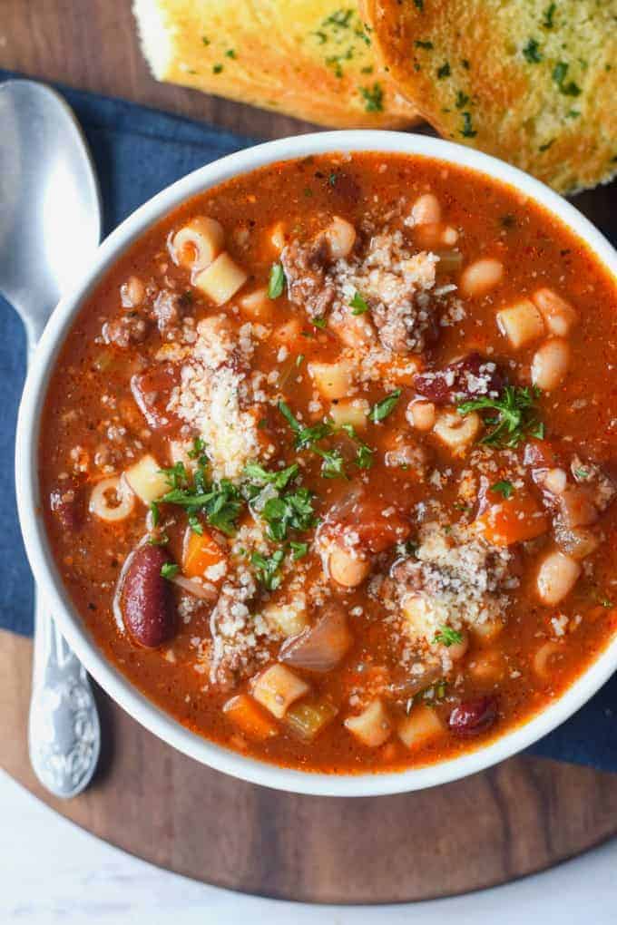 A bowl of food on a table, with Pasta and Soup