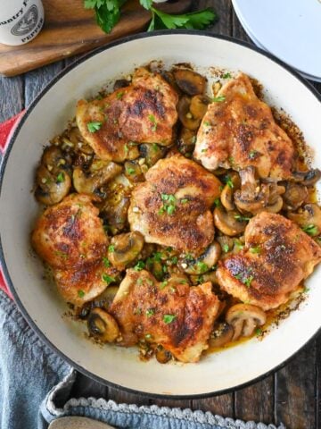 garlic mushroom chicken thighs in a skillet.