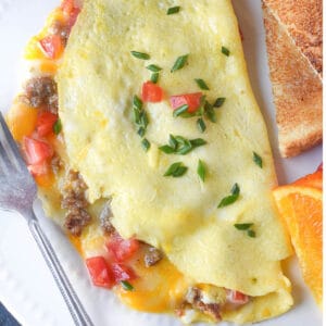 Omelet on a white plate with toast.