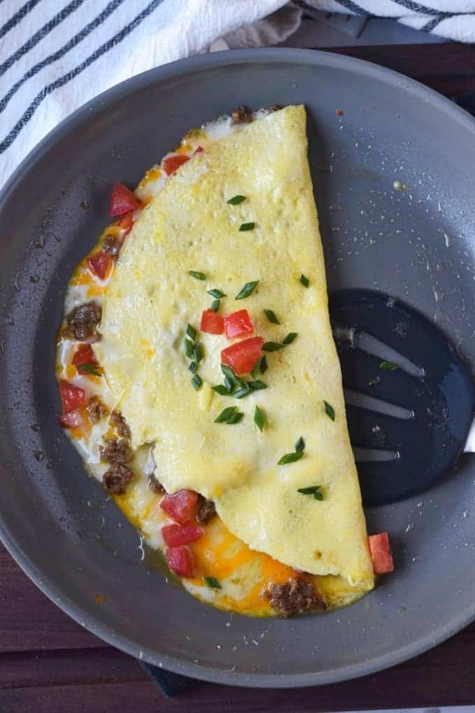 An omelet in a pan, with Sausage and Egg