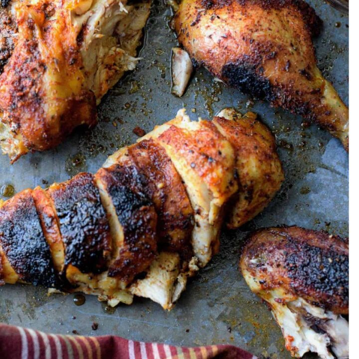 Cut up rotisserie chicken on a sheet pan.