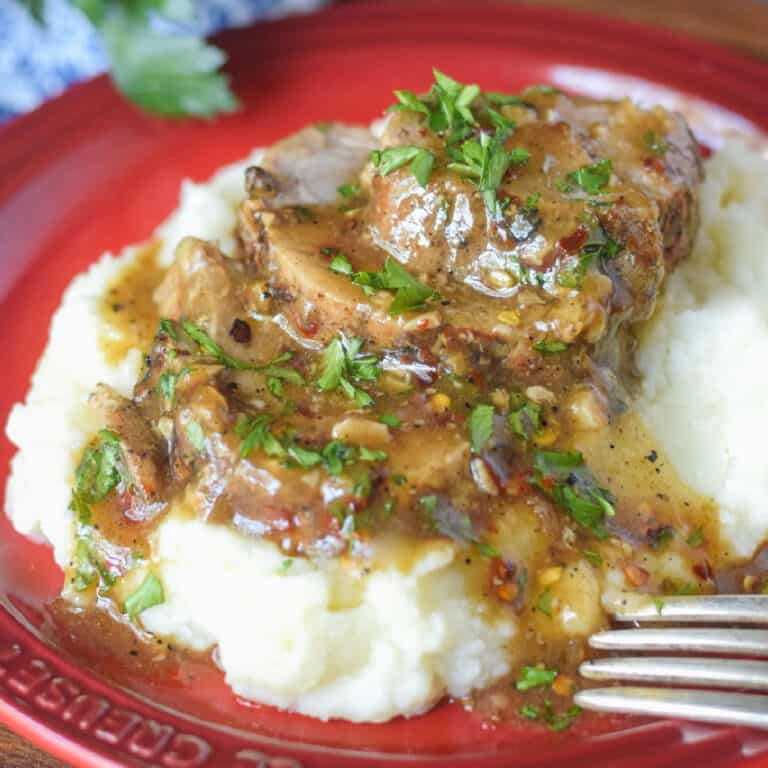 Sliced pork on mashed potatoes.
