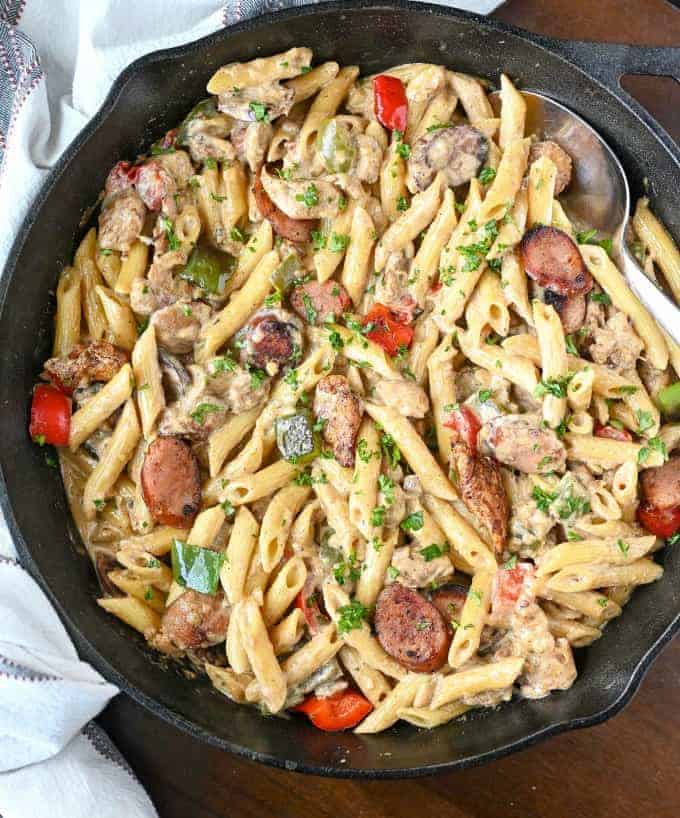 A skillet with chicken and pasta.