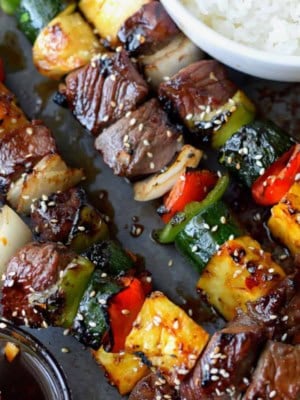 Teriyaki steak kebabs with a side of white rice.