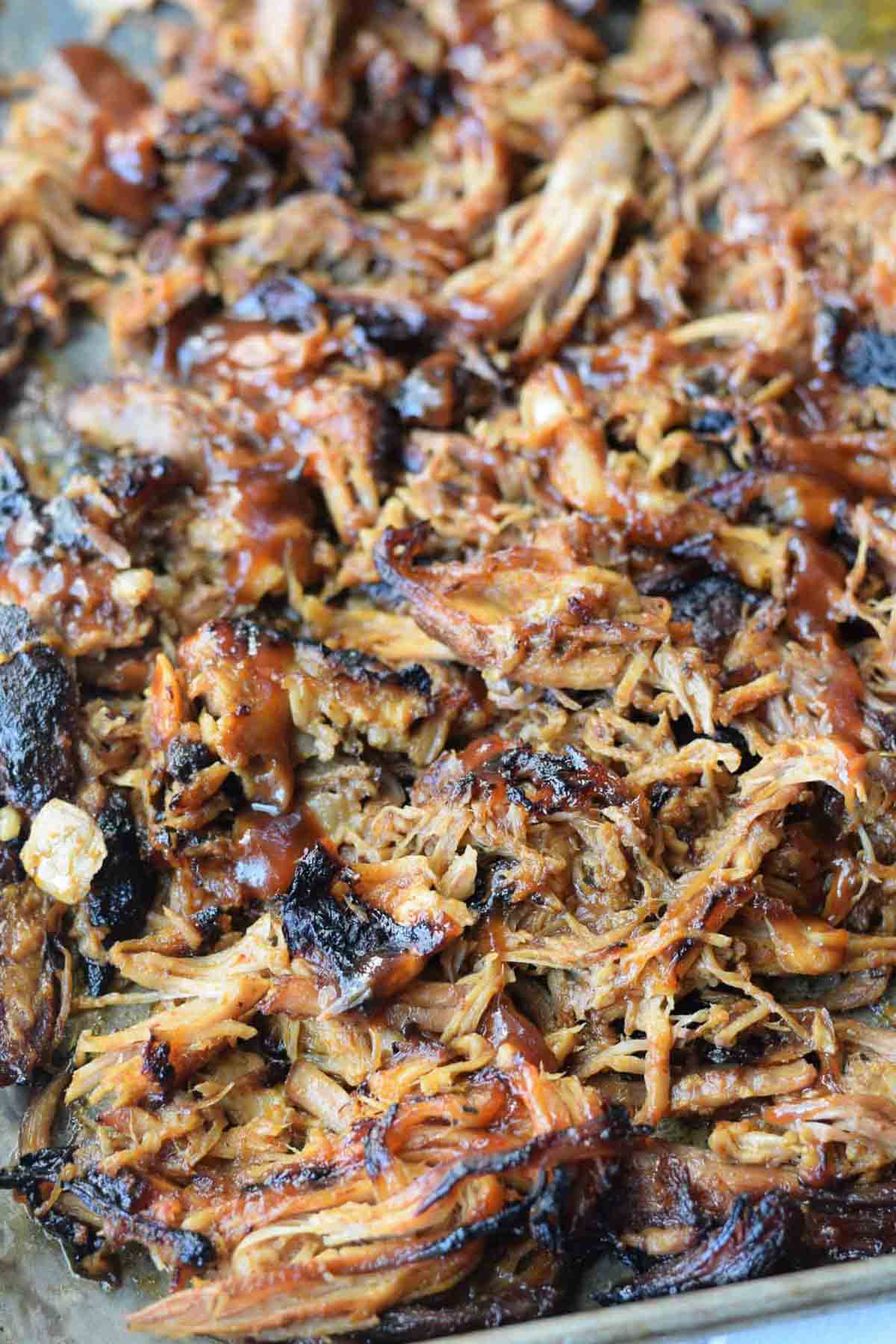 Pulled pork shredded on a baking sheet.