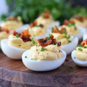chipotle bacon deviled eggs on a cutting board.