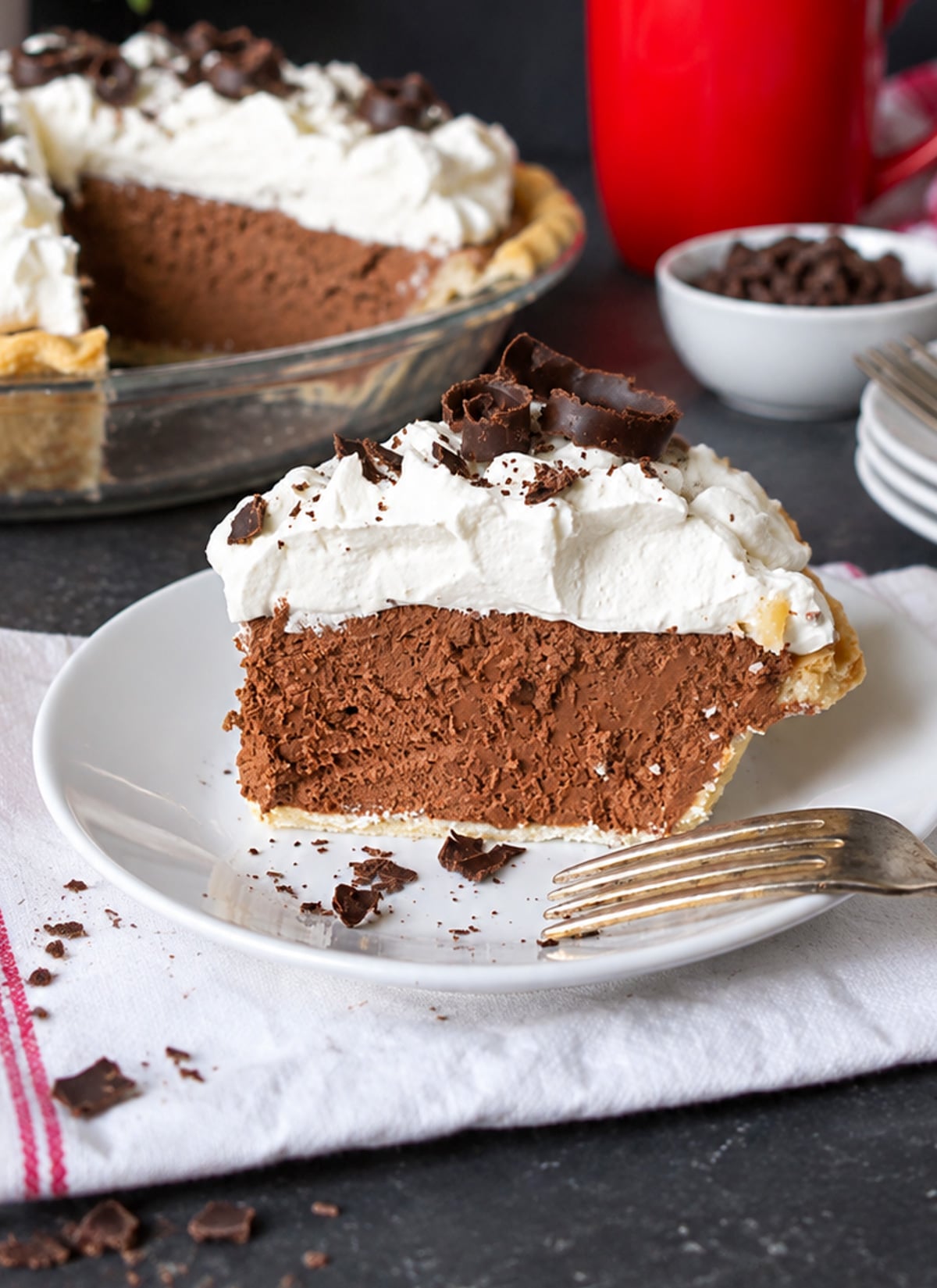 A slice of chocolate cream pie on a plate.