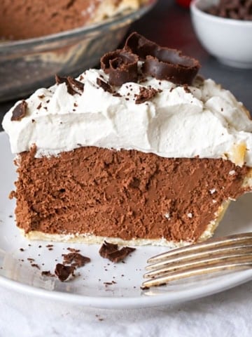 Chocolate cream pie on a plate.