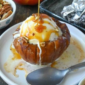 Caramel sauce drizzled on top of a baled apple.