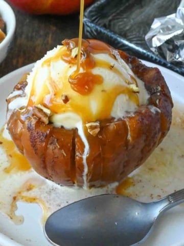 Caramel sauce drizzled on top of a baled apple.