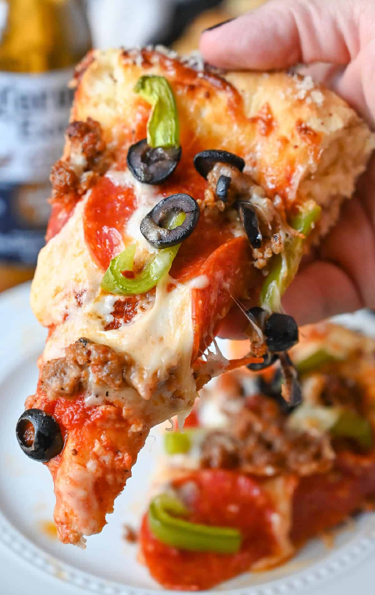 pizza being held in a hand.