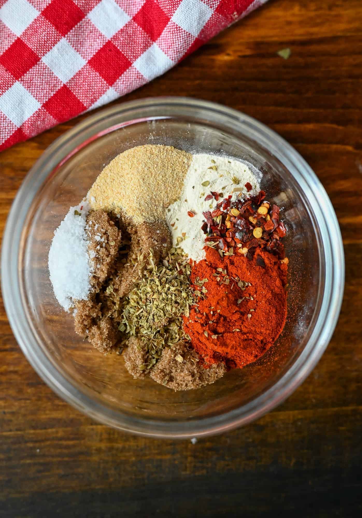 A combination of spices in a small bowl to put on the raw chicken.