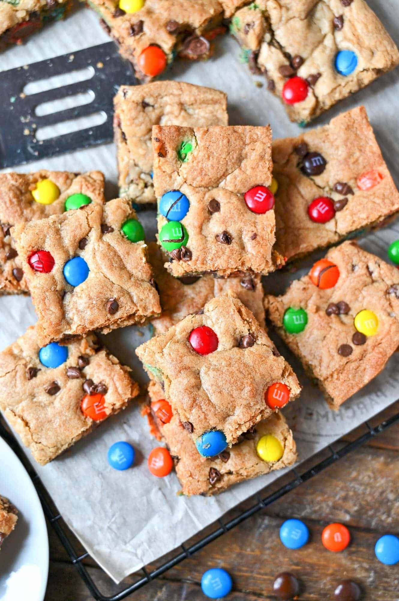 M&M cookie bars all cut and piled on top of each other.