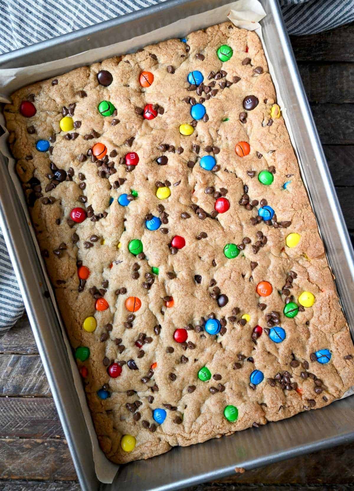 M&M cookie bars in a baking pan out of the oven.
