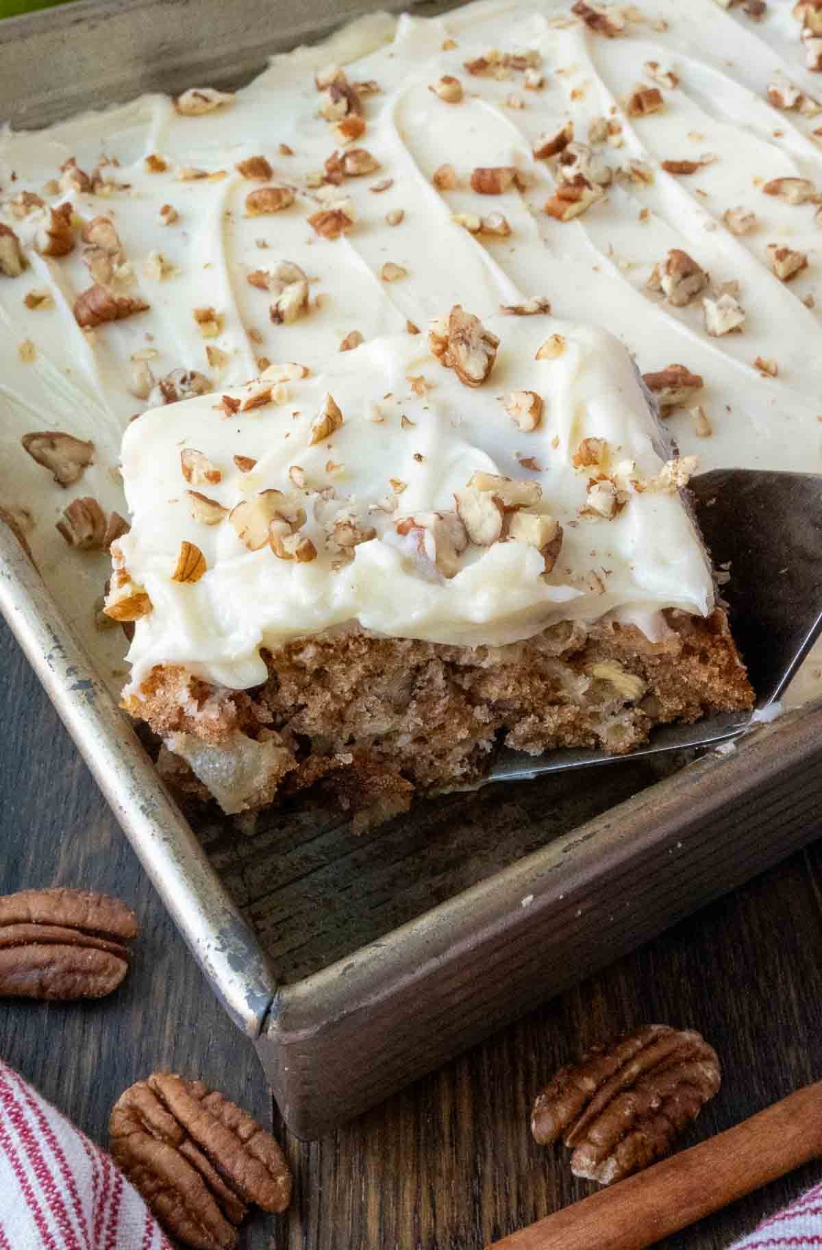 Apple cake being picked up with a spatula.