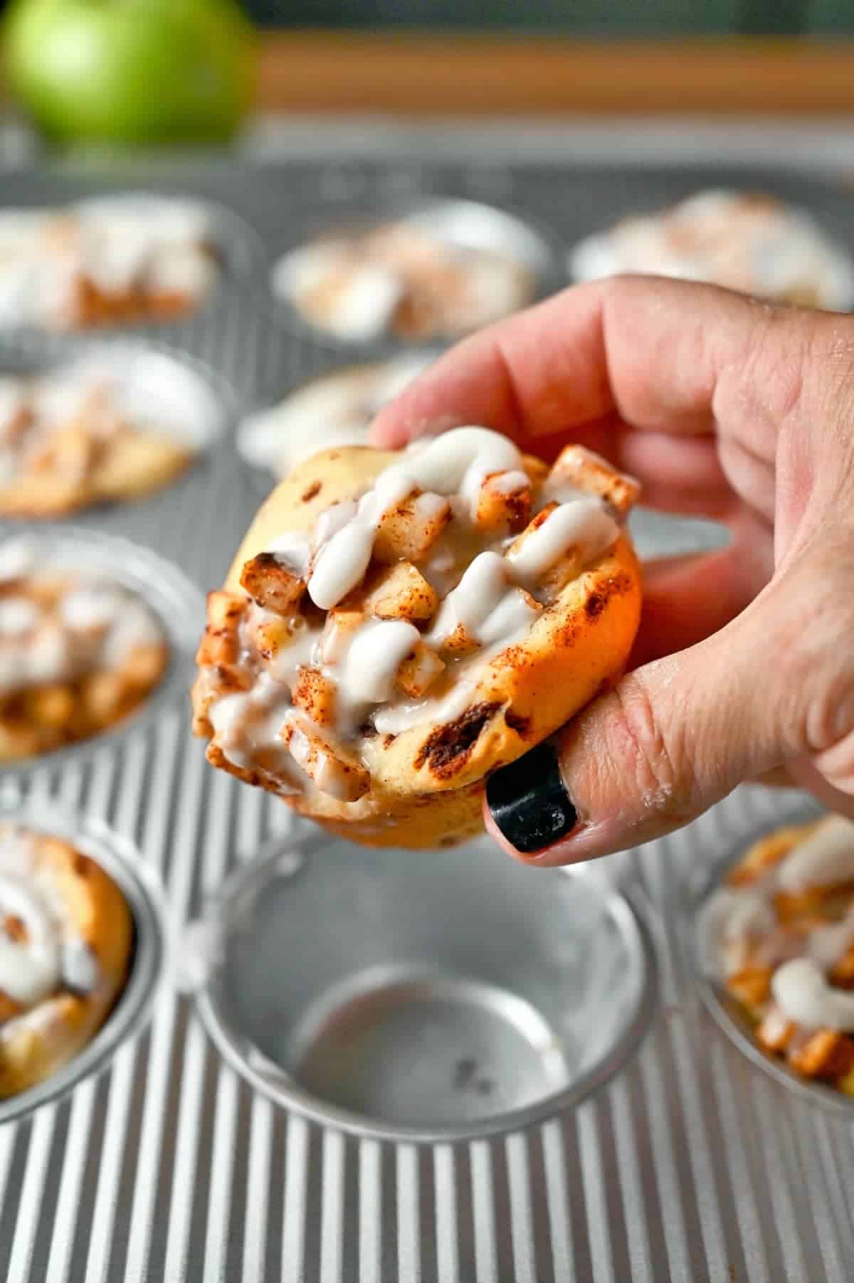 cinnamon roll being picked up and held.