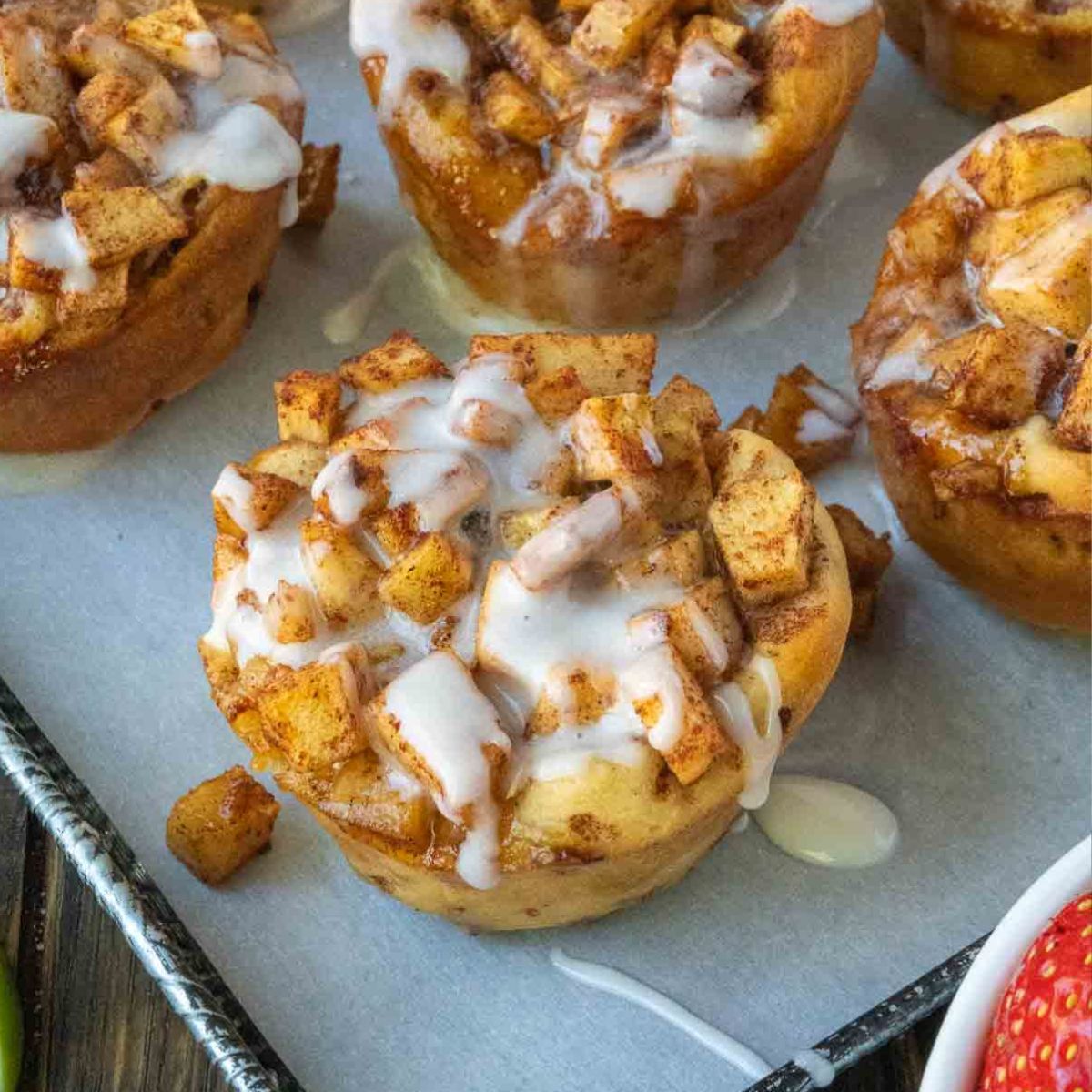 Apple cinnamon roll on a baking sheet.