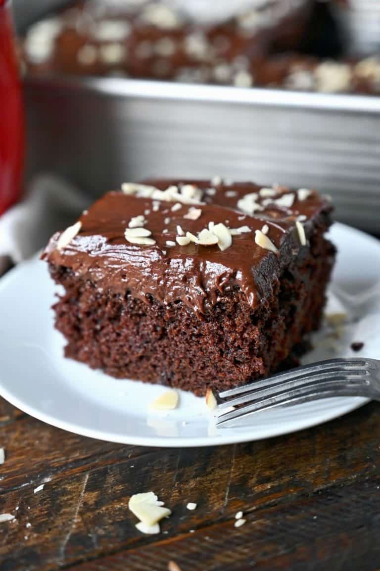 A piece of chocolate mayonnaise cake on a white plate.