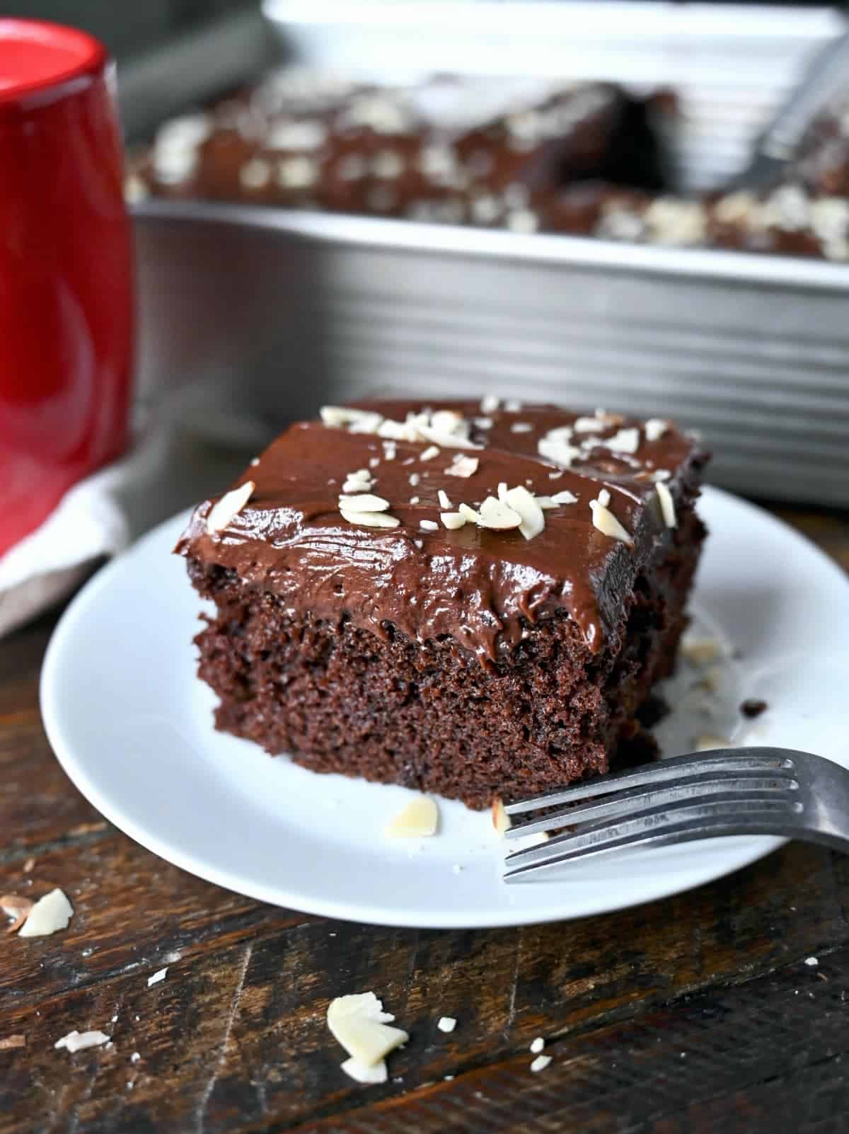 Chocolate cake on a white plate with a fork. 