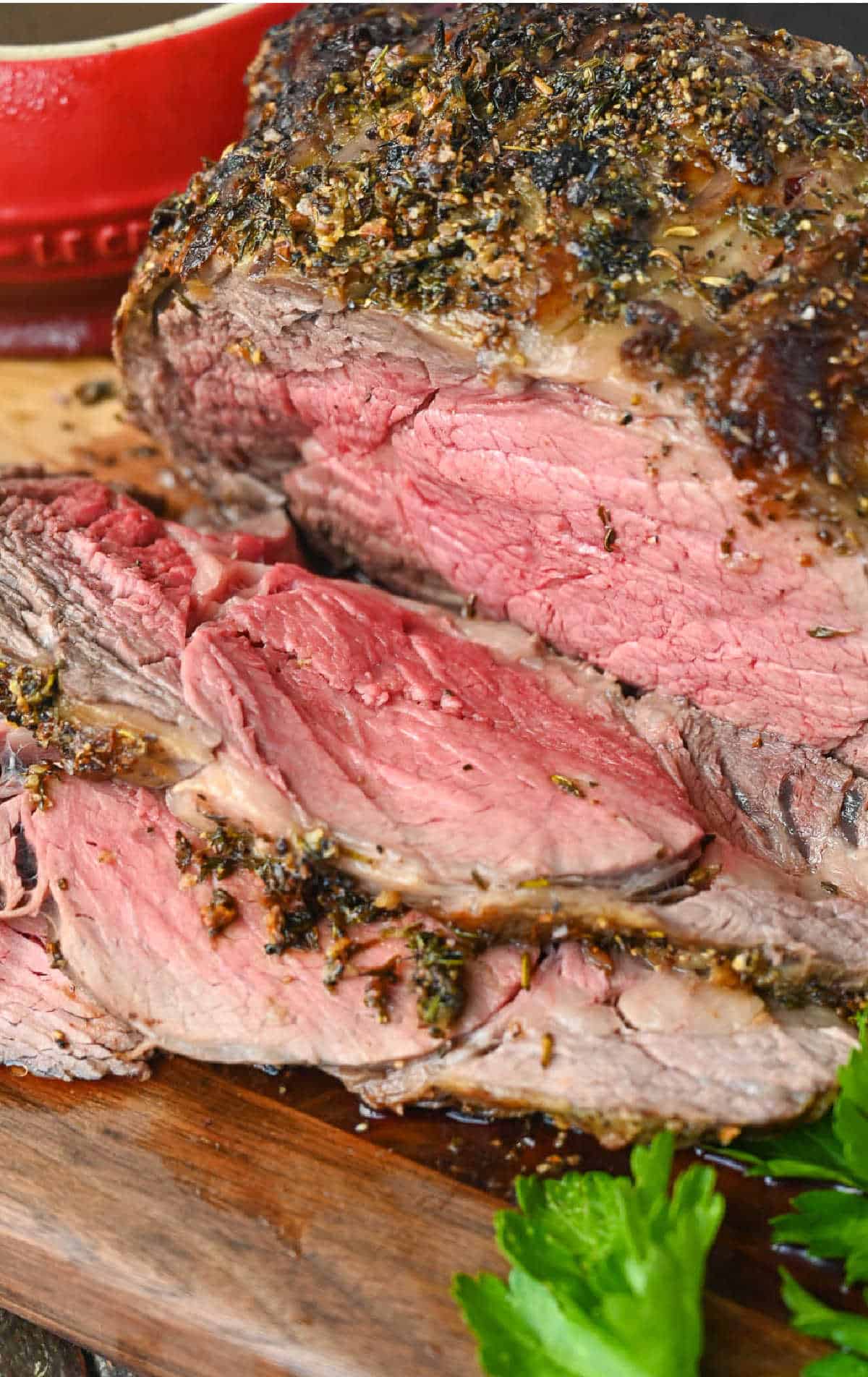 Sliced rib eye roast on a cutting board.