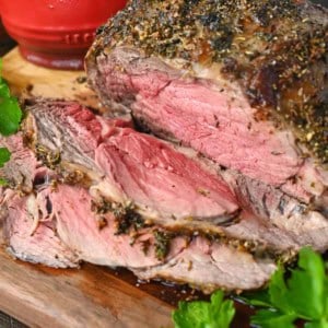 Rib eye roast sliced on a cutting board.